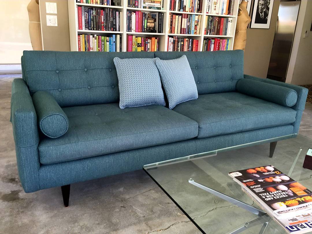 Upholstered sofa with tufted seats and backs with buttons in a weave teal/blue fabric